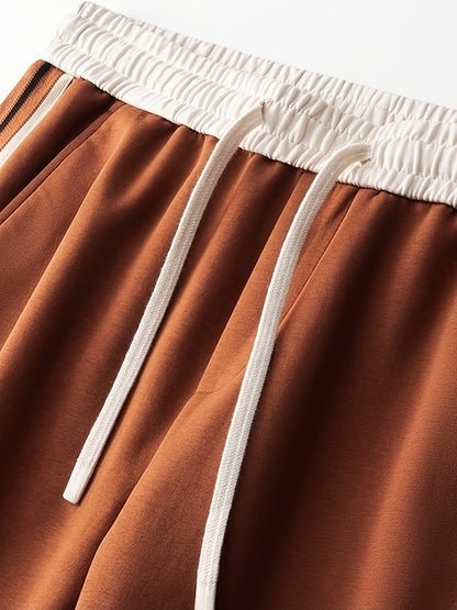 Close-up of brown sweatpants with white elastic waistband and drawstrings