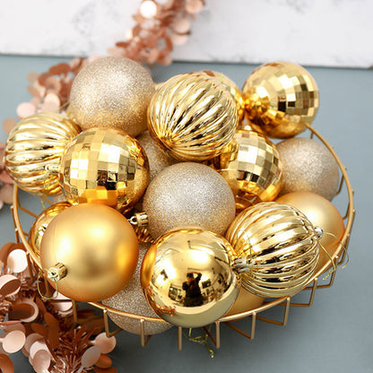 Metallic gold and glittery Christmas ornaments in varied textures inside a gold wire basket on a gray surface
