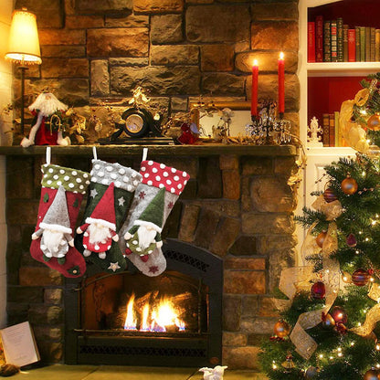 Cozy stone fireplace with Christmas stockings featuring gnome designs, lit candles, and decorated Christmas tree