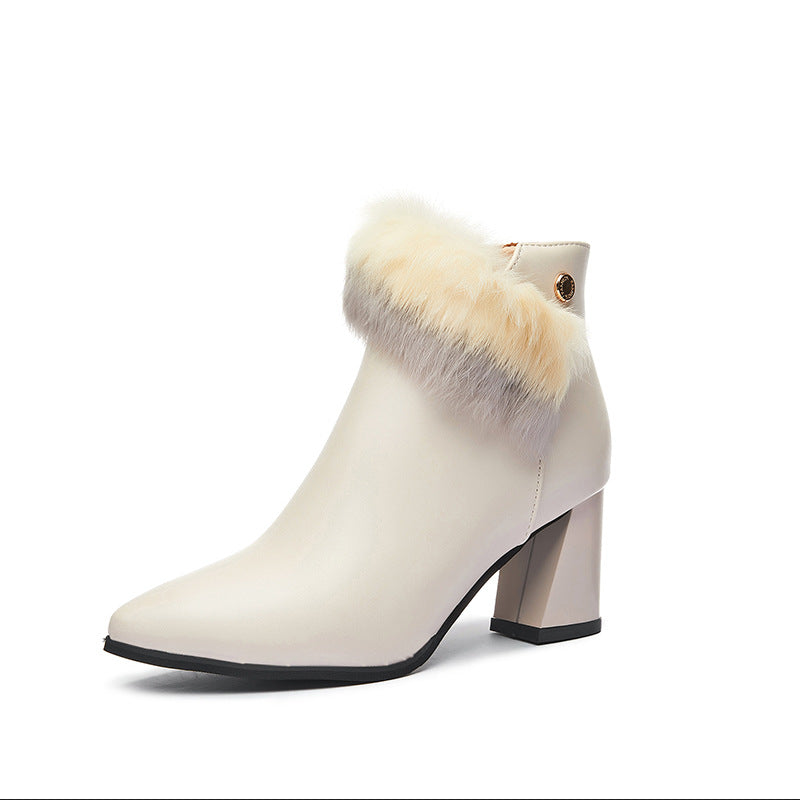 Elegant cream ankle boot with pointed toe, block heel, and beige faux fur trim