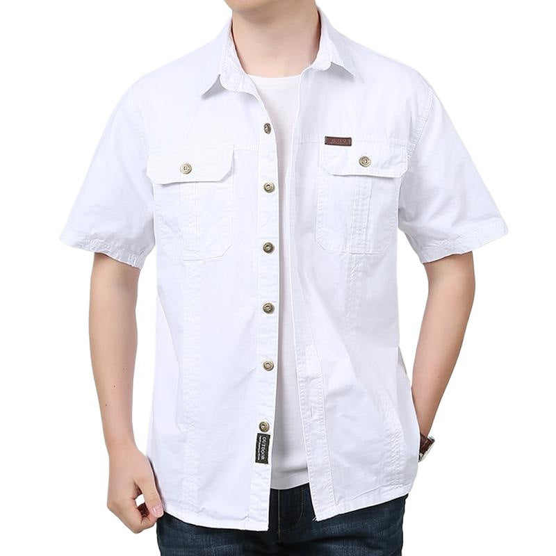 Man wearing casual white short-sleeve button-up shirt with chest pockets over white t-shirt
