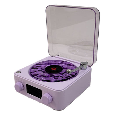 Compact purple turntable with clear dust cover and wavy vinyl record design