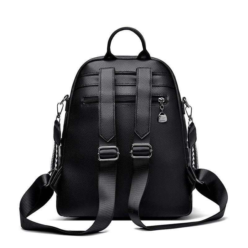 Black leather backpack with adjustable straps, top handle, and side metal clasps