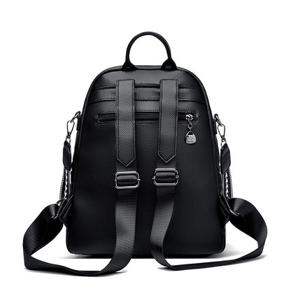 Black leather backpack with adjustable straps, top handle, and side metal clasps