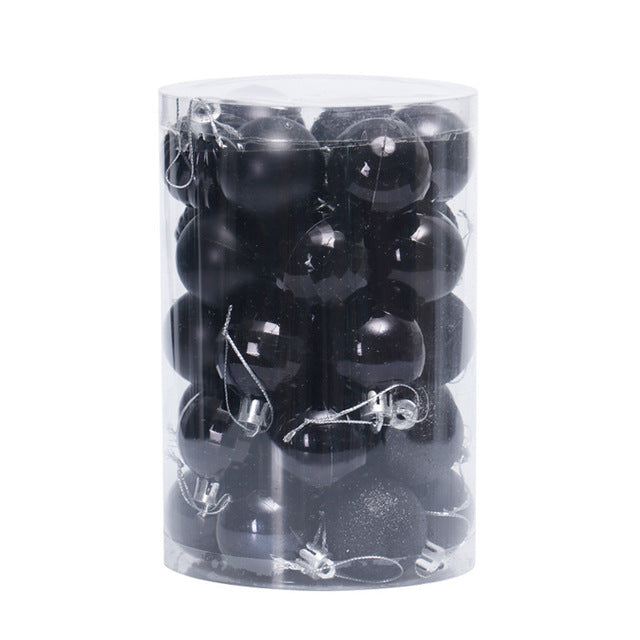 Transparent cylindrical container filled with black matte and glossy Christmas baubles