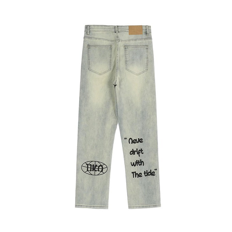 Back view of light washed denim jeans with black graphic text and patch pocket details