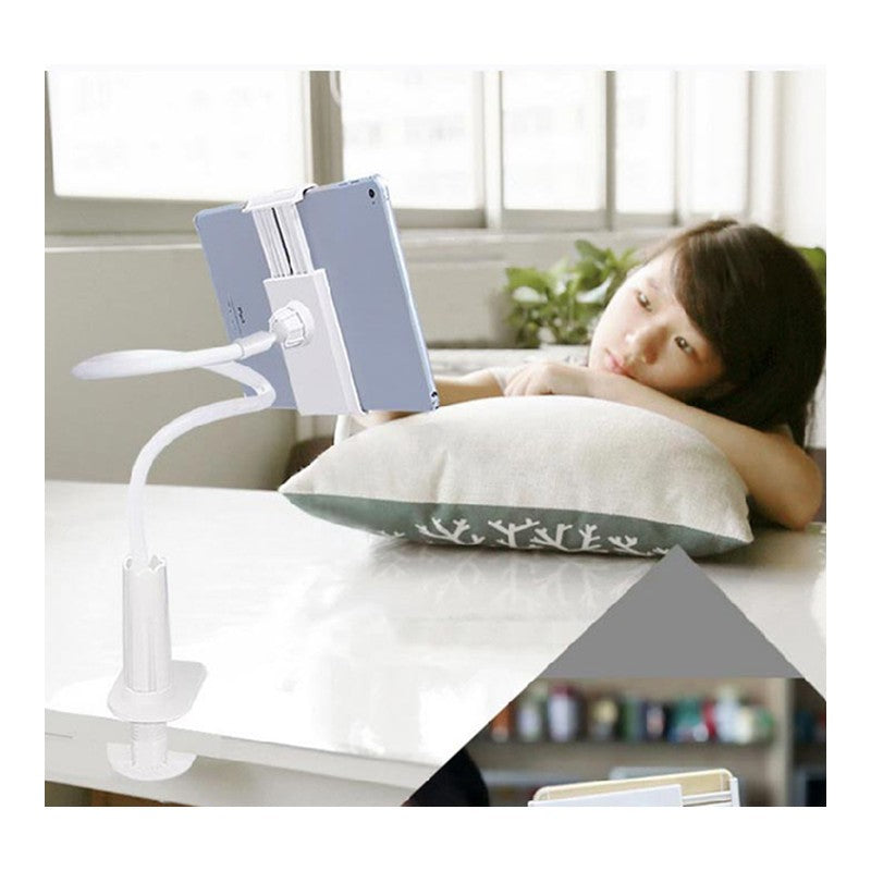 Flexible white tablet holder clamp attached to table with a person lying on a pillow watching the tablet