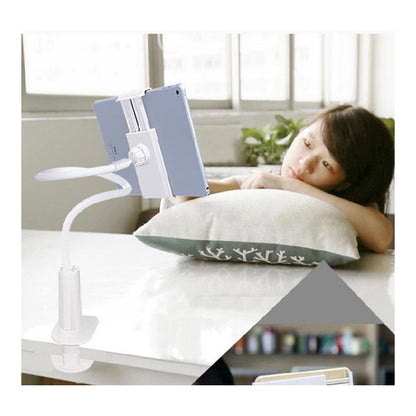 Flexible white tablet holder clamp attached to table with a person lying on a pillow watching the tablet