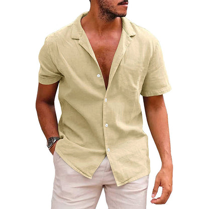 man wearing beige short-sleeve button-up linen shirt with pale pink shorts and wristwatch