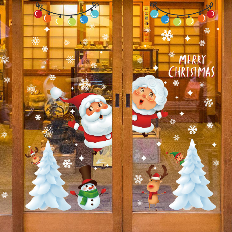 Glass door decorated with cartoon Santa, Mrs. Claus, snowman, reindeer, trees, colorful lights, and Merry Christmas text