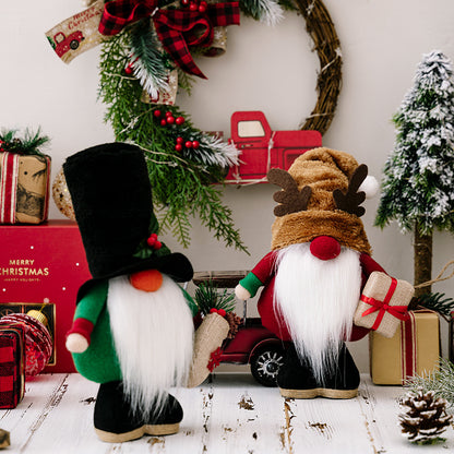 Christmas gnome decorations with white beards, festive gifts, wreath, and a red toy truck on white wooden floor