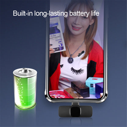 Smartphone with a clip-on microphone showing a woman on screen and a glowing battery icon