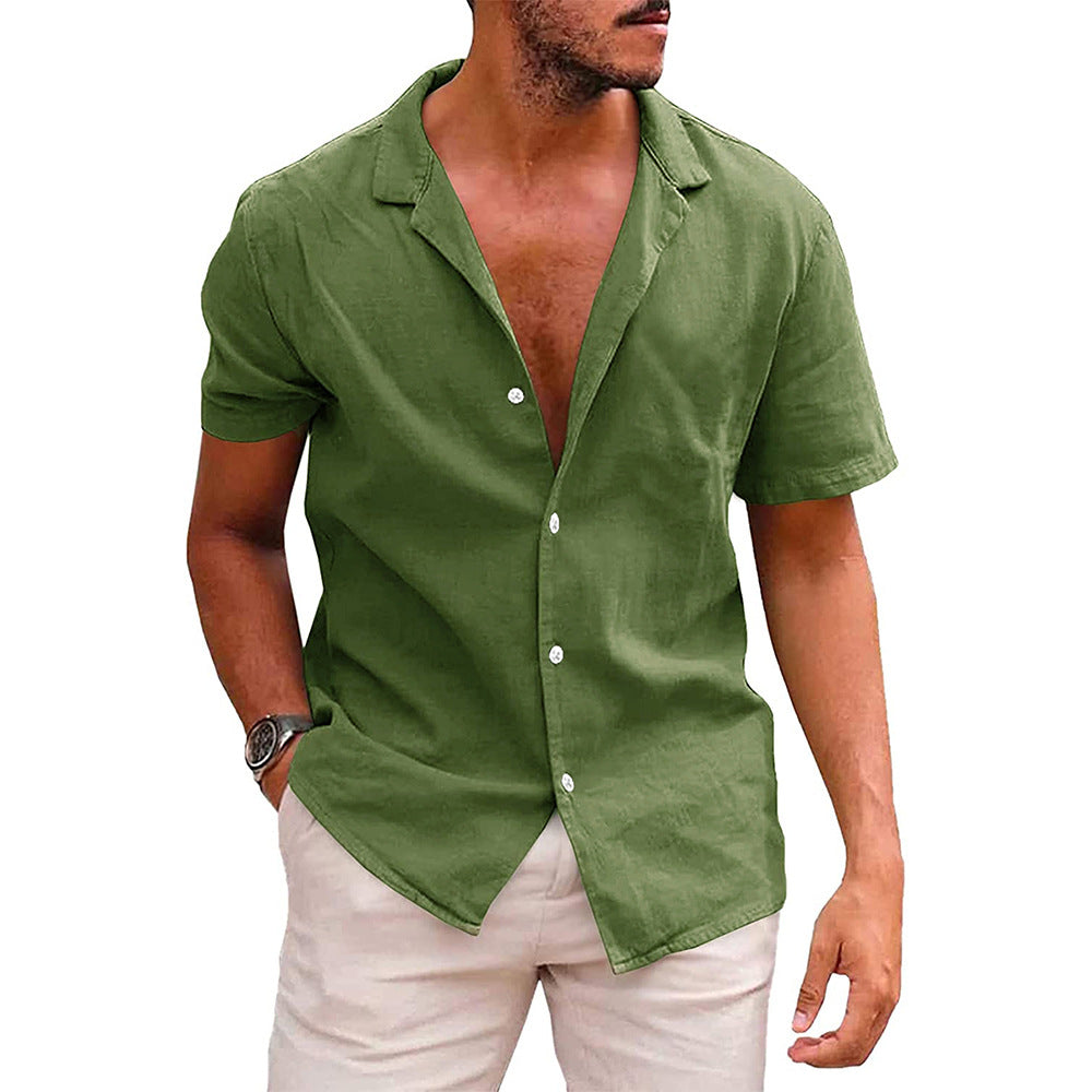 Man wearing casual olive green short-sleeve button-up shirt with beige pants and wristwatch