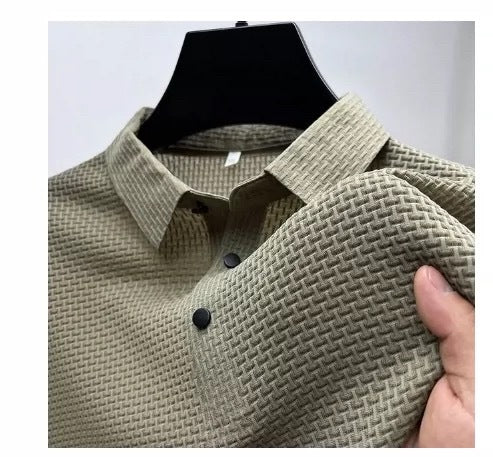 Close-up of a beige textured men's shirt with black buttons on a black hanger