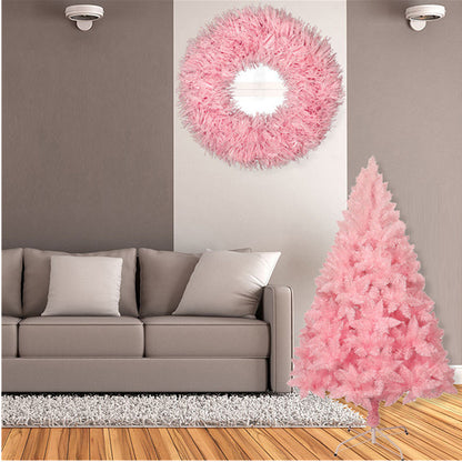 Modern living room with beige sofa, pink artificial Christmas tree, and matching pink wreath on wall
