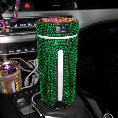 Green rhinestone car air purifier on vehicle center console with dashboard controls visible