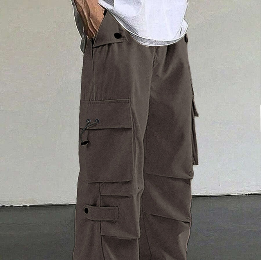 Men's brown cargo pants with multiple pockets and button details, worn with a white shirt