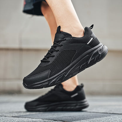 Close-up of black breathable mesh athletic sneakers with thick sole worn outdoors