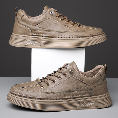 Brown leather casual sneakers with thick soles displayed on white platform against dark background