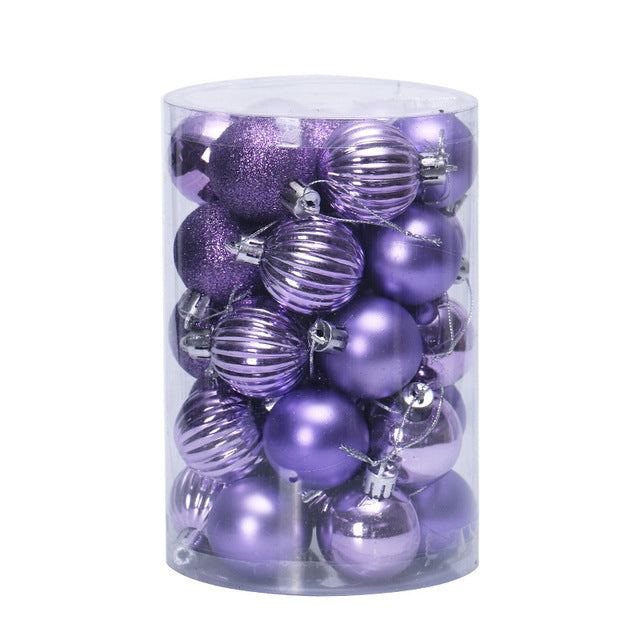 Clear cylindrical container filled with assorted purple Christmas tree ornaments including shiny, matte, ribbed, and glitter finishes
