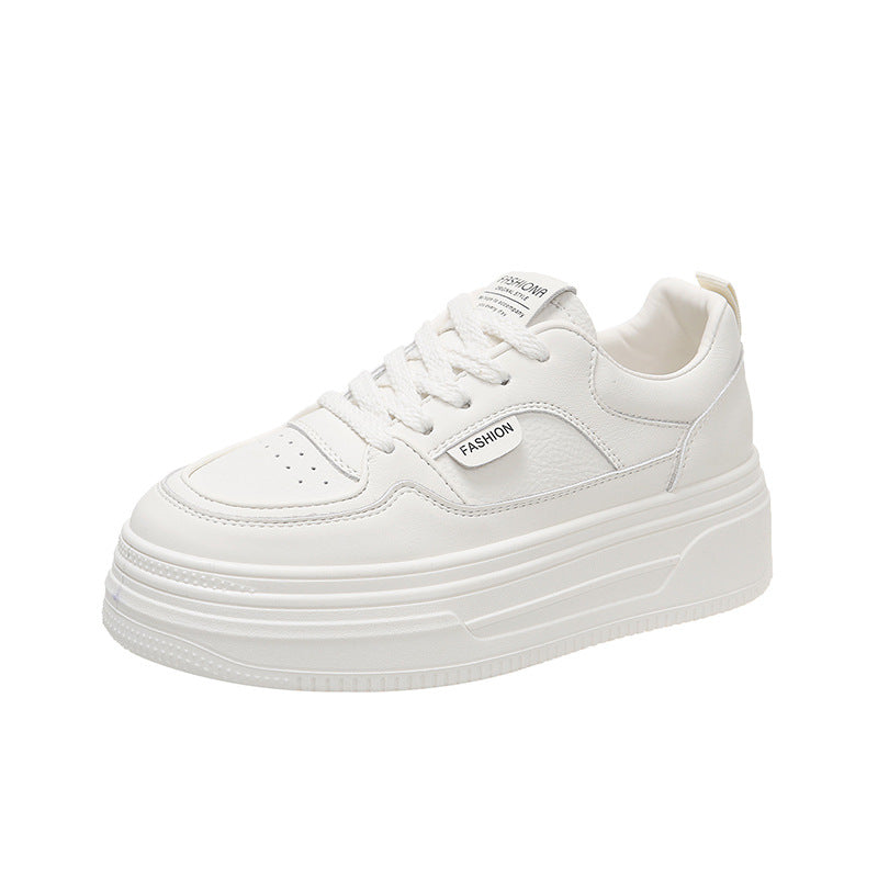 white platform sneaker with perforated toe and fashion tag on side