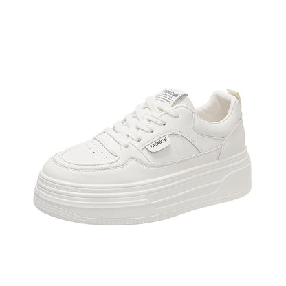 white platform sneaker with perforated toe and fashion tag on side