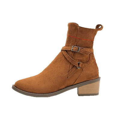 Brown suede ankle boot with low stacked heel and decorative buckle strap