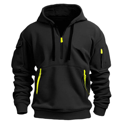 Black hooded sweatshirt with neon yellow zippers on front pockets, sleeve pocket, and half-zip collar