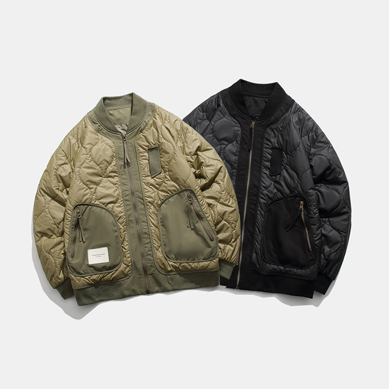 Two quilted bomber jackets in olive green and black with front zip and zippered pockets on gray background