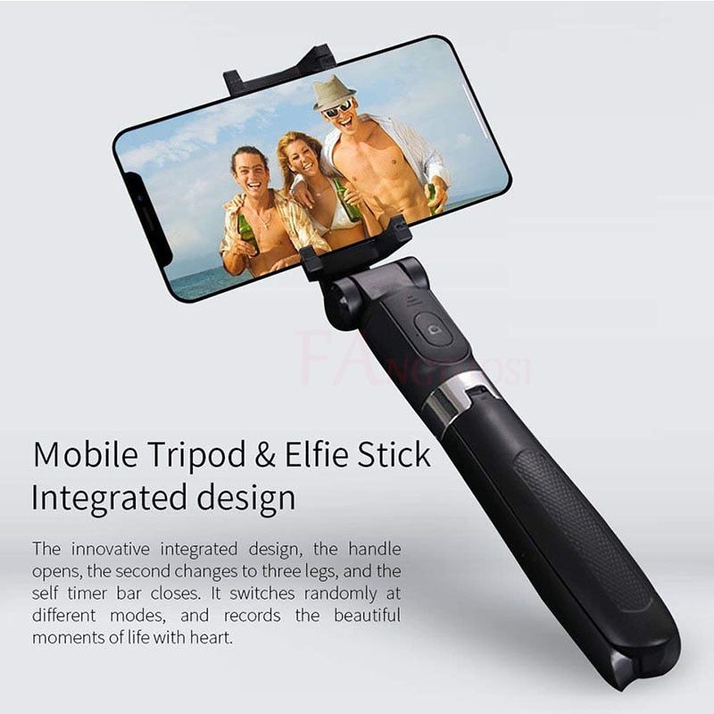 Black mobile tripod and selfie stick holding smartphone with beach photo of three friends
