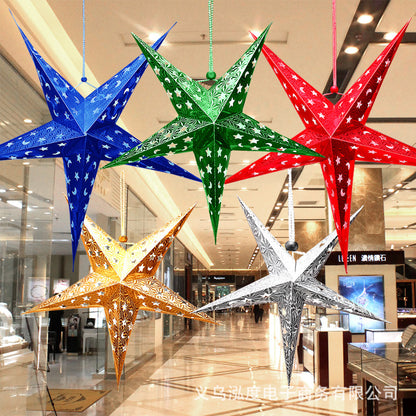 Colorful metallic star-shaped hanging decorations in blue, green, red, gold, and silver in a shopping mall