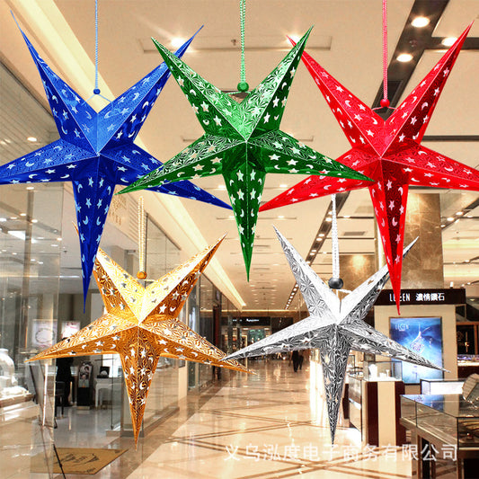 Colorful metallic star-shaped hanging decorations in blue, green, red, gold, and silver in a shopping mall