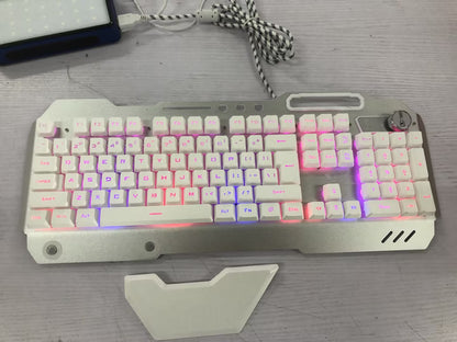 White mechanical gaming keyboard with multicolor LED backlight and volume control knob on gray wooden desk