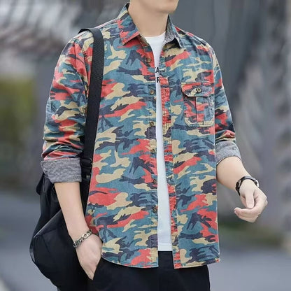 Man wearing rolled-up camouflage button-up shirt with colorful pattern, black bag strap, and wristwatch