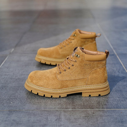 Pair of tan suede lace-up work boots with padded collar on grey tiled floor