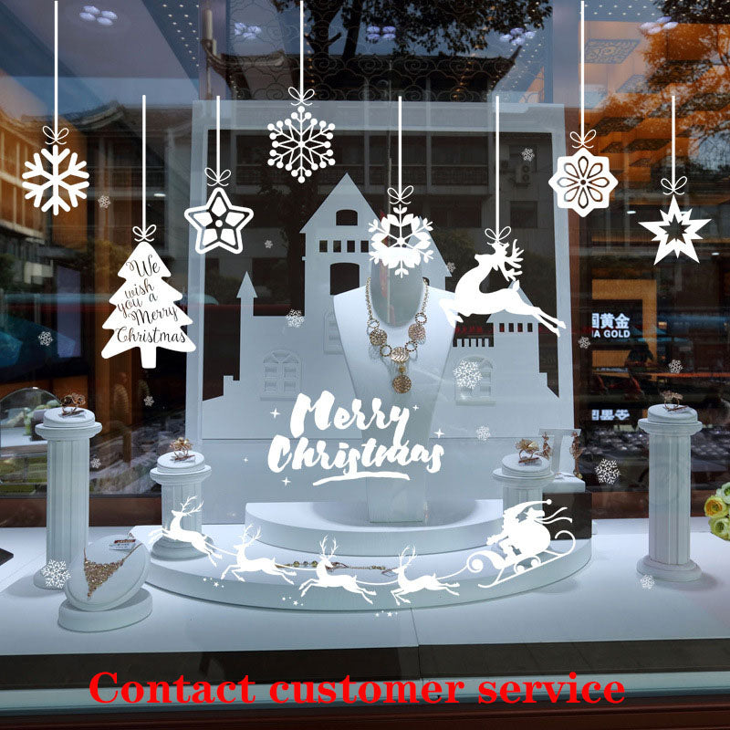 Jewelry store Christmas window display with white snowflakes, reindeer, sleigh, and festive necklace on pedestal