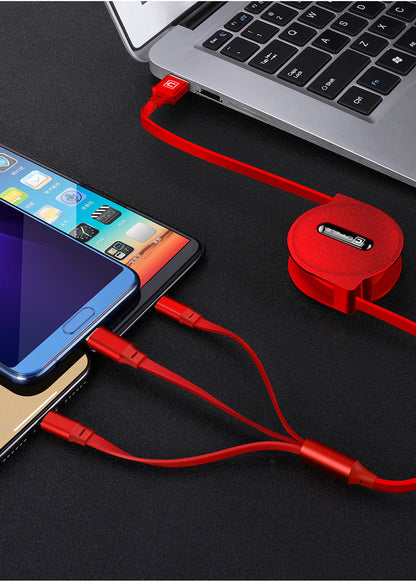 Red retractable multi-device charging cable connected to a laptop and charging three smartphones on black surface