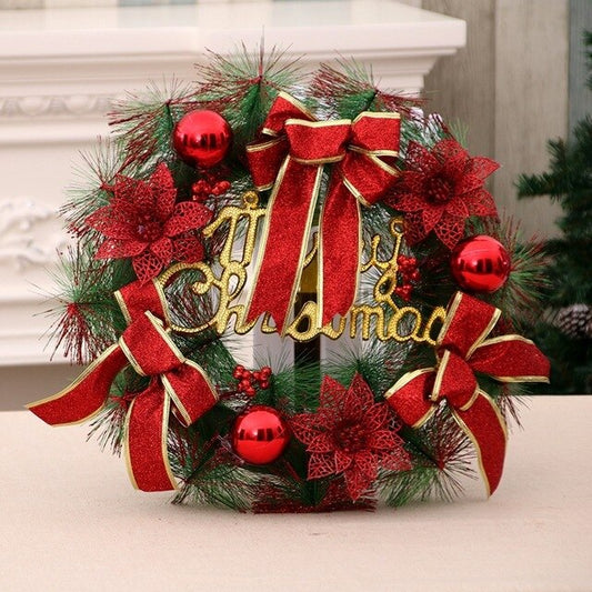 Festive Christmas wreath decorated with red bows, baubles, poinsettias, and gold 'Merry Christmas' sign