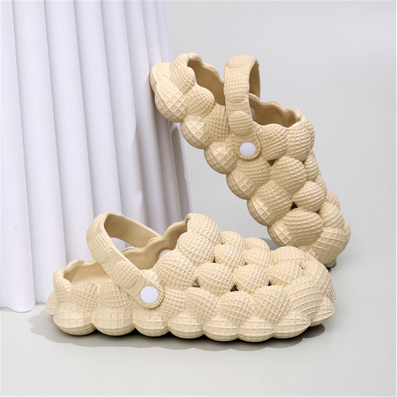 Beige bubble-textured slip-on clogs with strap and waffle pattern, displayed on white surface