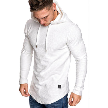 Man wearing white textured long-sleeve hoodie with drawstrings and curved hem, paired with blue jeans