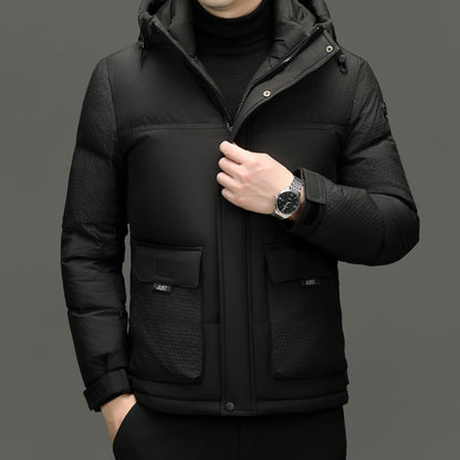 Men's black padded winter jacket with front pockets and high collar, worn with black turtleneck