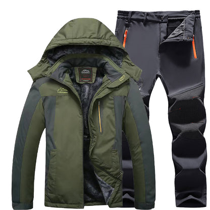 Men's green and black outdoor winter jacket with hood and fleece lining paired with black hiking pants with knee pads and orange zipper pockets
