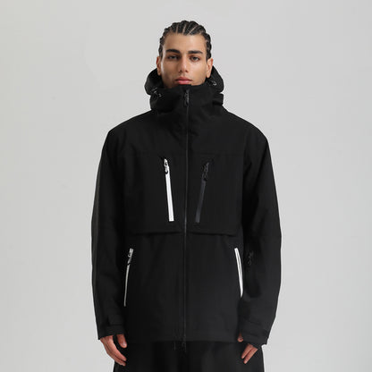 Man wearing black winter jacket with white and black zipper details and hood on gray background