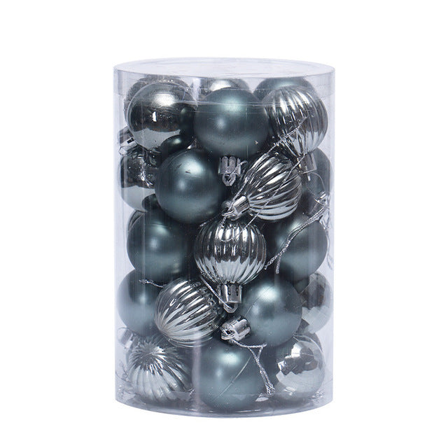 Clear cylindrical container filled with silver and metallic gray Christmas ornament balls, matte and ribbed textures