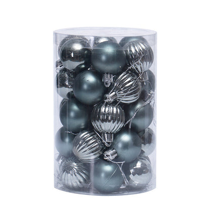 Clear cylindrical container filled with silver and metallic gray Christmas ornament balls, matte and ribbed textures