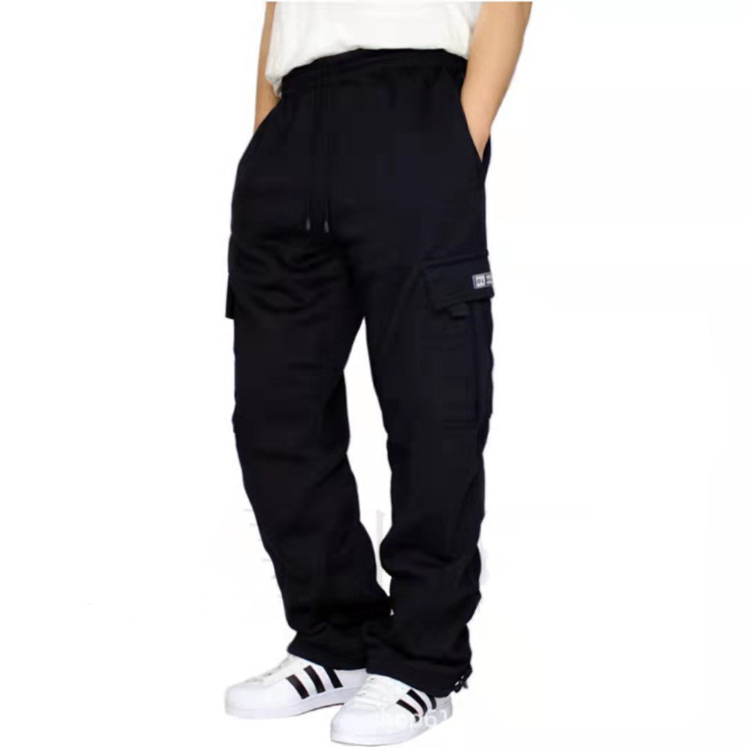 Person wearing black cargo pants with side pockets and white sneakers with black stripes