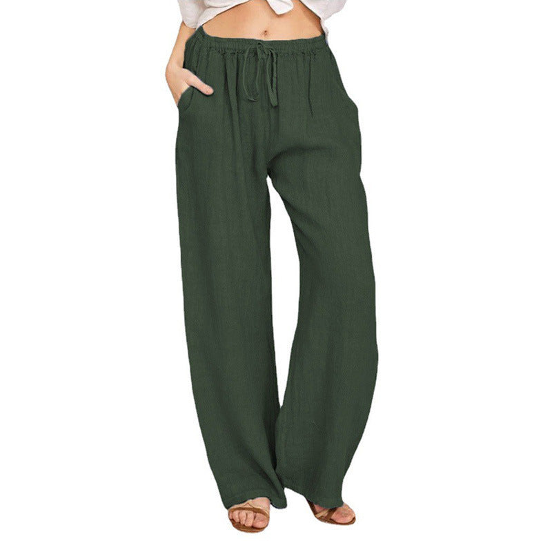 Woman wearing loose olive green linen pants with drawstring waist and side pockets