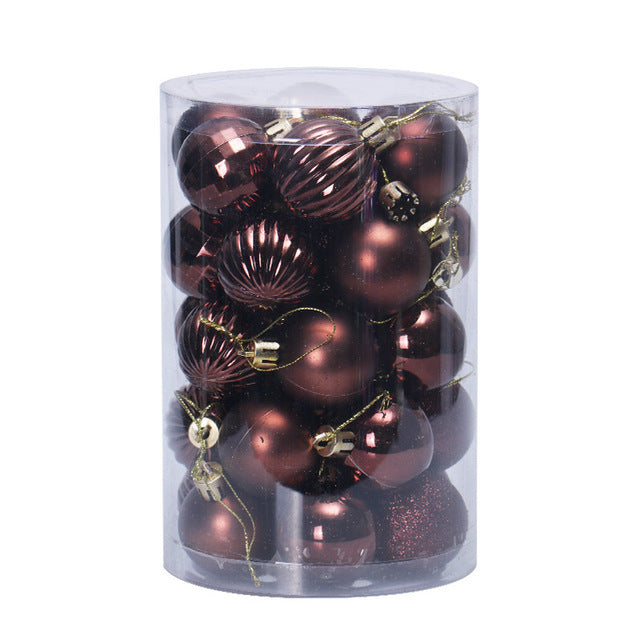 Set of shiny and matte dark red Christmas baubles in clear cylindrical box