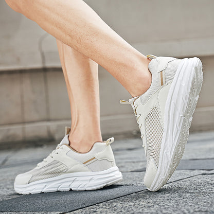 Close-up of person wearing beige mesh running shoes on urban pavement, lightweight athletic sneakers