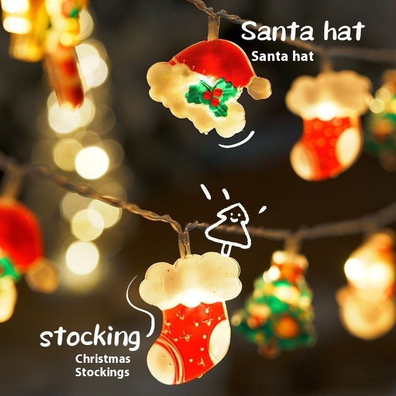 Christmas string lights featuring glowing Santa hat and red stocking decorations with festive bokeh background